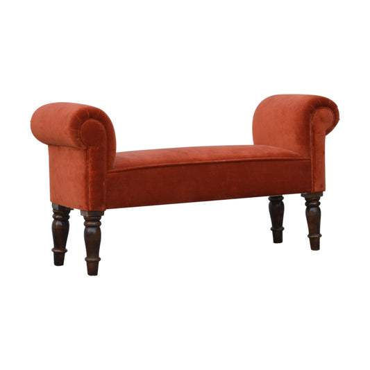 Red velvet bench with dark wooden legs on a white background